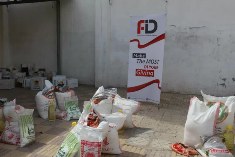 FID, in cooperation with the Emirates International University in Sana'a, distributes more than 700 food baskets to needy families